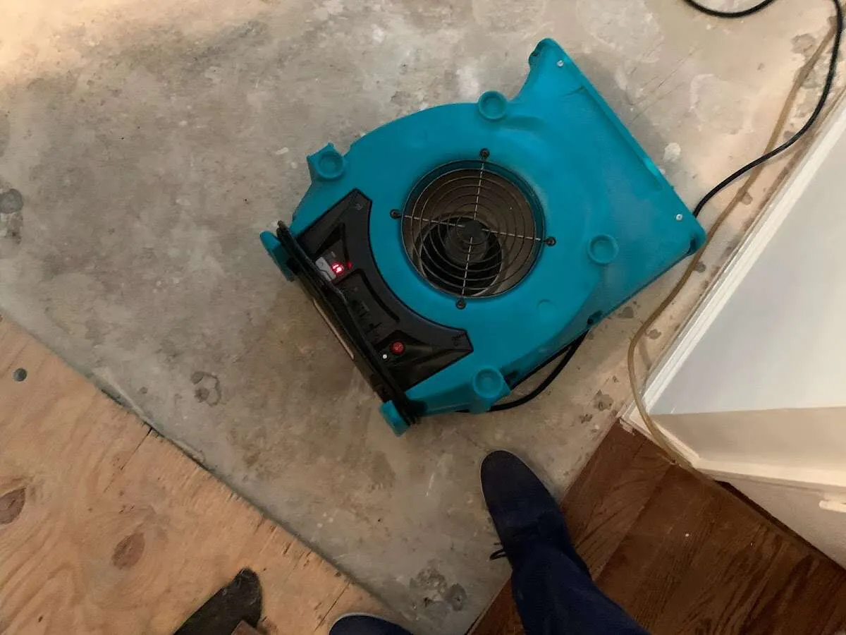 Air mover drying subfloor during Commercial Water Damage Restoration in Lake Worth Beach